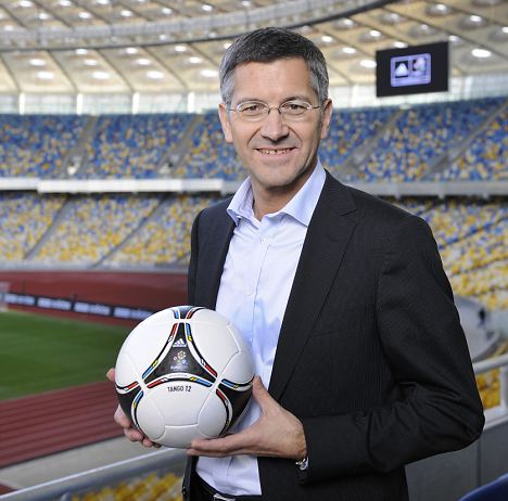 KIEV, UKRAINE - DECEMBER 02:  Herbert Hainer, CEO adidas Group poses with the adidas Tango 12, the official matchball for the UEFA Euro 2012 tournament at the Olympiyskiy Stadium on December 2, 2011 in Kiev, Ukraine. (Photo by Gary Prior/Getty Images for adidas)